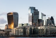 View of the City of London’s illuminated financial district skyline at dusk View of the City of London’s illuminated financial district skyline at dusk