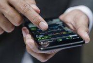 businessman using a mobile phone to check stock market data businessman using a mobile phone to check stock market data