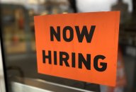 “now hiring” sign posted on business door “now hiring” sign posted on business door