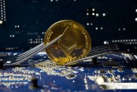 Ethereum An ether (ETH) coin with forks on a motherboard