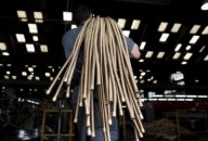 A file photo shows an employee carrying copper hoses at the Sociedade Paulista de Tubos Flexiveis (SPTF) metallurgical company which manufactures flexible metal hoses, in Sao Paulo April 20, 2012. A file photo shows an employee carrying copper hoses at the Sociedade Paulista de Tubos Flexiveis (SPTF) metallurgical company which manufactures flexible metal hoses, in Sao Paulo April 20, 2012.