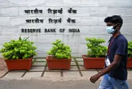 A pedestrian walks past the entrance of the Reserve Bank of India (RBI) headquarters in Mumbai