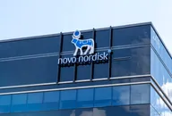 Novo Nordisk logo displayed on the glass facade of a modern corporate office building