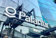 Palantir Technologies logo displayed on the glass facade of a modern office building