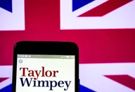 Smartphone displaying the Taylor Wimpey logo against a Union Jack background, representing the British housebuilding company.