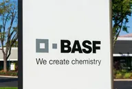 BASF logo sign with the slogan “We create chemistry” displayed outside a company building