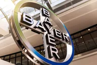 Large Bayer logo sign displayed inside a modern corporate building
