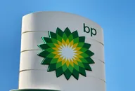 BP logo displayed on a white cylindrical sign against a clear blue sky