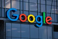 Google logo displayed on the exterior of a modern glass office building