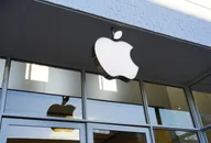 Apple logo sign displayed outside a modern storefront