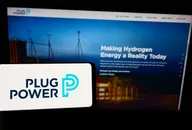 Plug Power logo displayed on a mobile device with the company’s website about hydrogen energy in the background