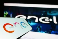 Smartphone displaying Enel logo with blurred corporate website in the background