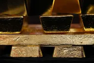Primo piano di lingotti d'oro impilati con superfici metalliche riflettenti