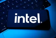 Intel logo displayed on a smartphone screen placed on a laptop keyboard