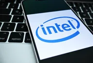 Smartphone displaying Intel logo placed on a laptop keyboard