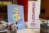 Leonardo aerospace company display featuring aircraft models, branding, and exhibition materials, representing the defense and aviation industry