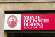Monte dei Paschi di Siena bank logo displayed on a red sign on a building facade