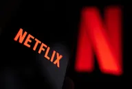Smartphone displaying the Netflix logo with the streaming platform's iconic red “N” blurred in the background, representing the global entertainment and streaming service.