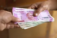 Small stack of Indian rupee notes changing hands