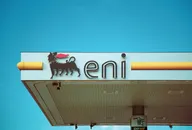 Eni petrol station sign and canopy viewed from below under a bright blue sky.