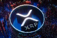 XRP logo depicted in white pinpoint lights on a blue and multicoloured background of pinpoint lights
