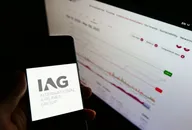 Stuttgart, Germany - 03-10-2021: Person holding smartphone with logo of airline company International Airlines Group (IAG) on screen in front of website. Focus on phone display. Unmodified photo.