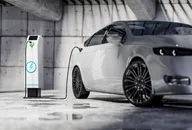 Charging an electric car with a public charger in a parking lot sustainable climate visuals 
