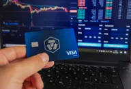 Man holding Crypto.com debit card in hand