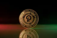 Polkadot DOT cryptocurrency physical coin placed on reflective surface and lit with green and red lights
