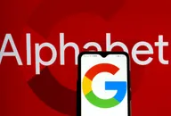 Alphabet company logo with Google logo displayed on a smartphone against a red background