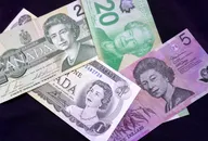 Canadian and Australian currency with portraits of Queen Elizabeth II