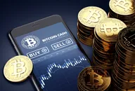 Bitcoin cash tokens next to a smartphone with trading bitcoin cash