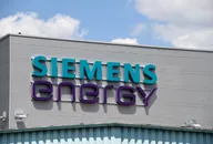 Siemens Energy Logo an der Außenfassade eines Industriegebäudes vor blauem Himmel