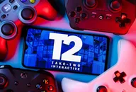 Take-Two Interactive Logo auf einem Smartphone-Bildschirm, umgeben von Gaming-Controllern