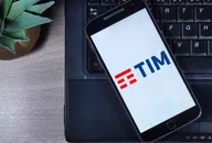 Smartphone displaying TIM logo placed on a laptop keyboard