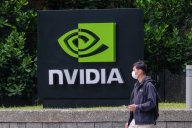 A man wearing a mask walks past an Nvidia logo in Taipei