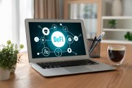 A laptop features an illustration explaining decentralised finance (DeFI)