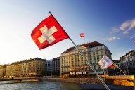 Flag of the Geneva Canton and flag of Switerland in the city center of Geneva on the Mont Blanc Bridge