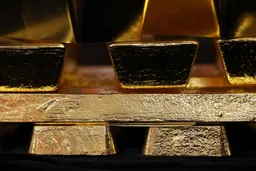 Close-up of stacked gold bullion bars with reflective metallic surfaces