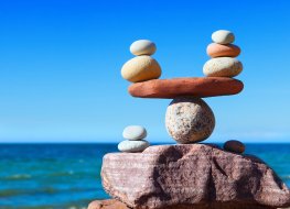 US Economy Rocks delicately balanced beside the sea