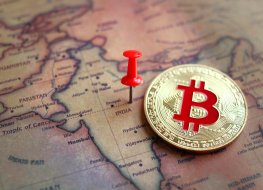 Bitcoin token lying on top of a map of India