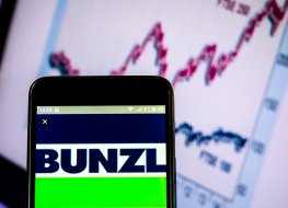 Bunzl logo on a smartphone in front of a FTSE chart