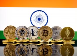 A range of cryptocurrencies in front of the Indian flag