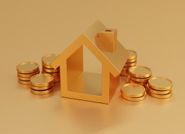 Gold coins next to a gold house