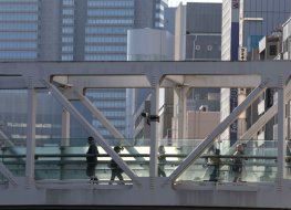 Pedestrians on a bridge in Japan's central business district
