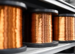 Rolls of copper wire on a factory shelf 