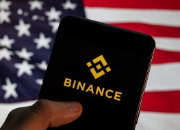 In this photo illustration the cryptocurrency exchange trading platform Binance logo is seen on an Android mobile device with United States of America flag in the background