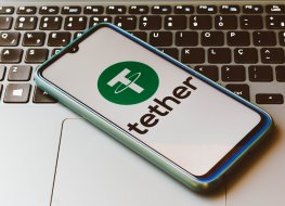 In this photo illustration the Tether logo seen displayed on a smartphone