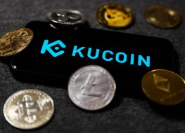 Smartphone displays KuCoin name and logo surrounded by cryptos