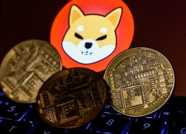 Shiba Inu cryptocurrency logo displayed on a phone screen and representation of cryptocurrency are seen in this illustration photo taken in Krakow, Poland on 2 November 2021